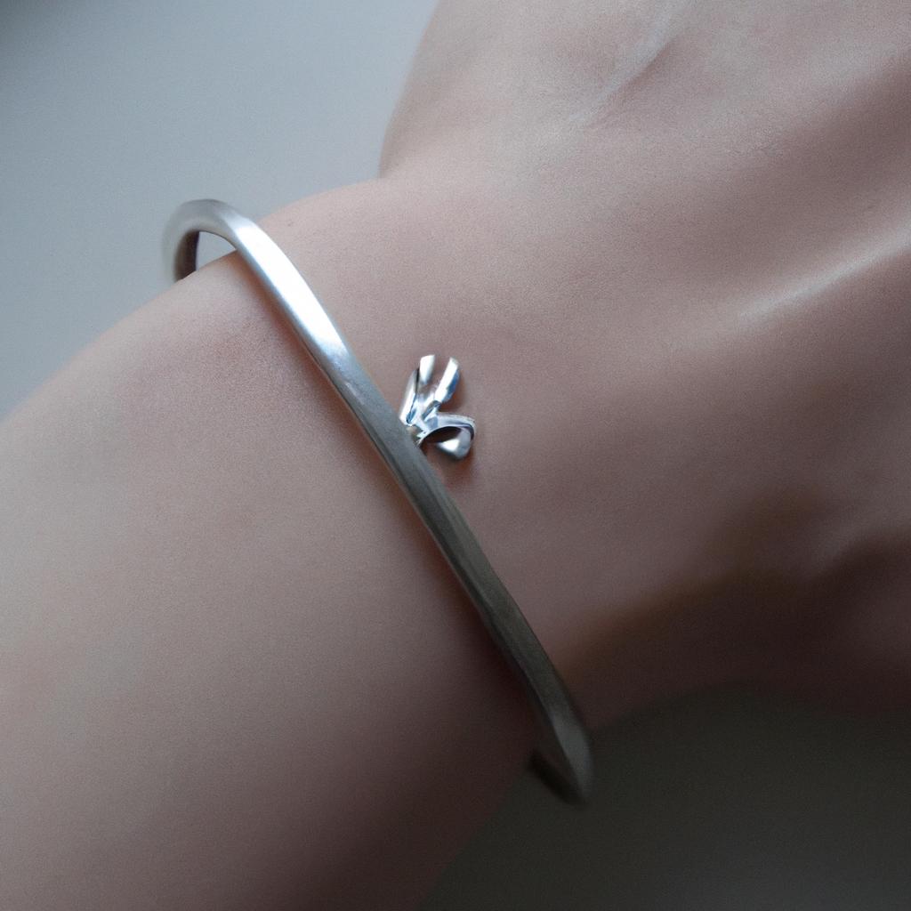 This sleek silver bracelet features a minimalist design with a small rabbit emblem, perfect for everyday wear.